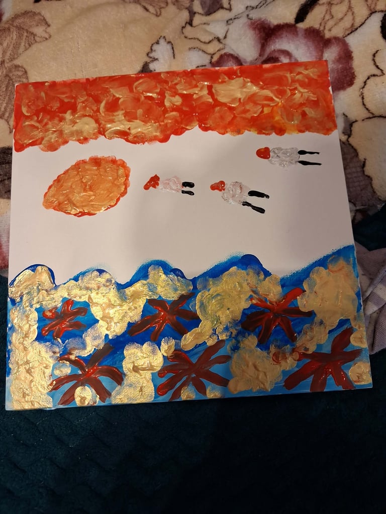 Childs artwork showing a painted ocean scene with red sun, simple face design, blue waves, and red starfish on white paper